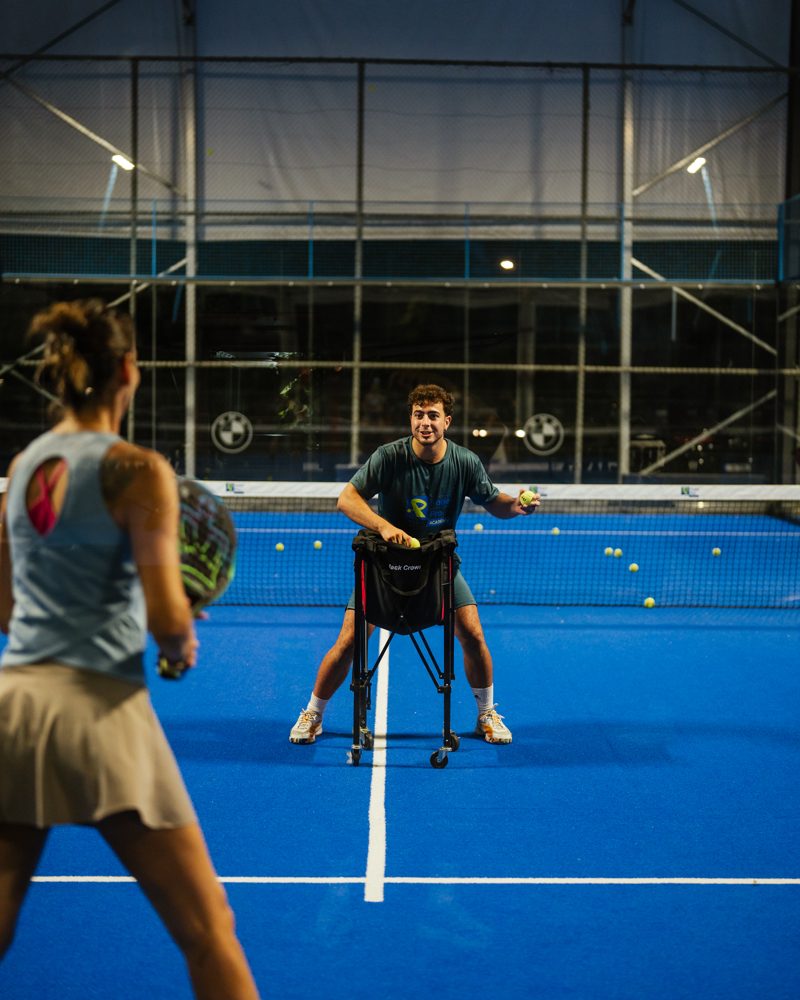 Coach feeding balls during a training session